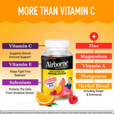 Airborne daily wellness Support Gummies with a glass of water