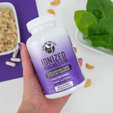 Alkaline for Life Ionized Magnesium 110mg capsules on a wooden surface