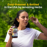 Amazing Herbs Black Seed Oil 257g pouring into a spoon