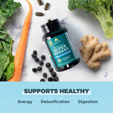 Ancient Nutrition Greens Superfood Blend scoop with powder on a wooden table