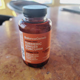 BalanceGenics Turmeric Ginger Curcumin 1000mg capsules with a measuring spoon