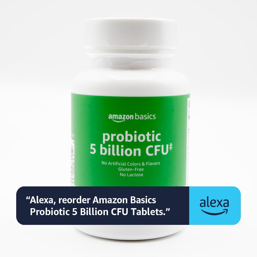 Basics Probiotic Capsules on a wooden table with a glass of water