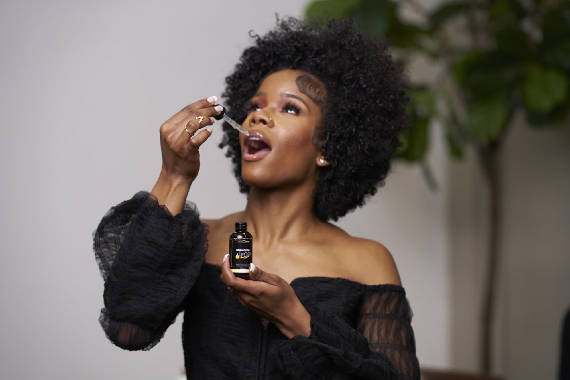 BASK & LATHER Gro & Glow Liquid Vitamin bottle in lifestyle setting