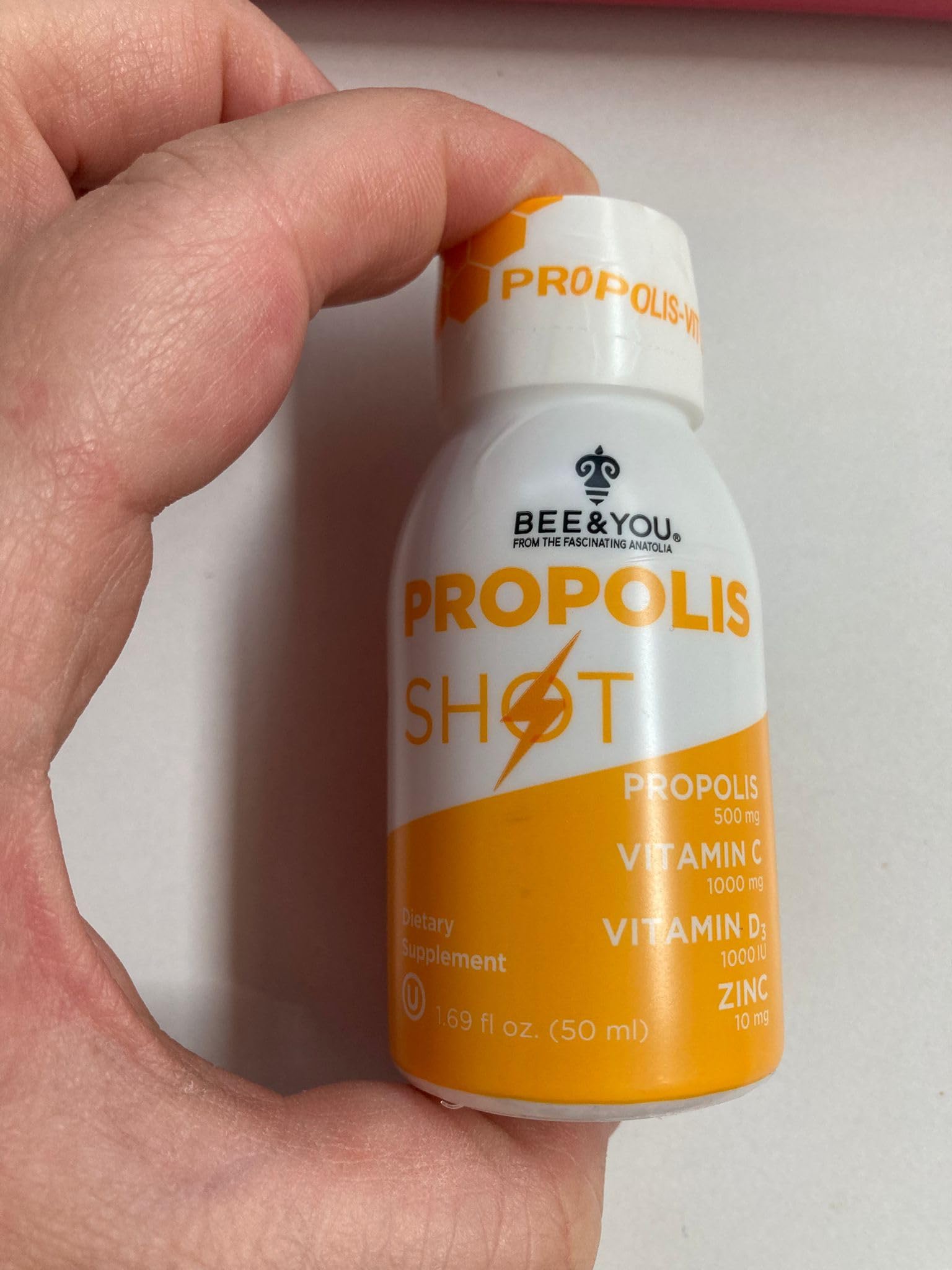 BEE & YOU Propolis daily wellness Support Supplement with a spoon of honey