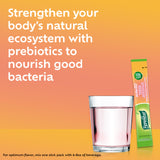 Benefiber Strawberry Lemonade stick pack beside a glass of water