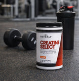 Beverly International Creatine Select 480g with a glass of water