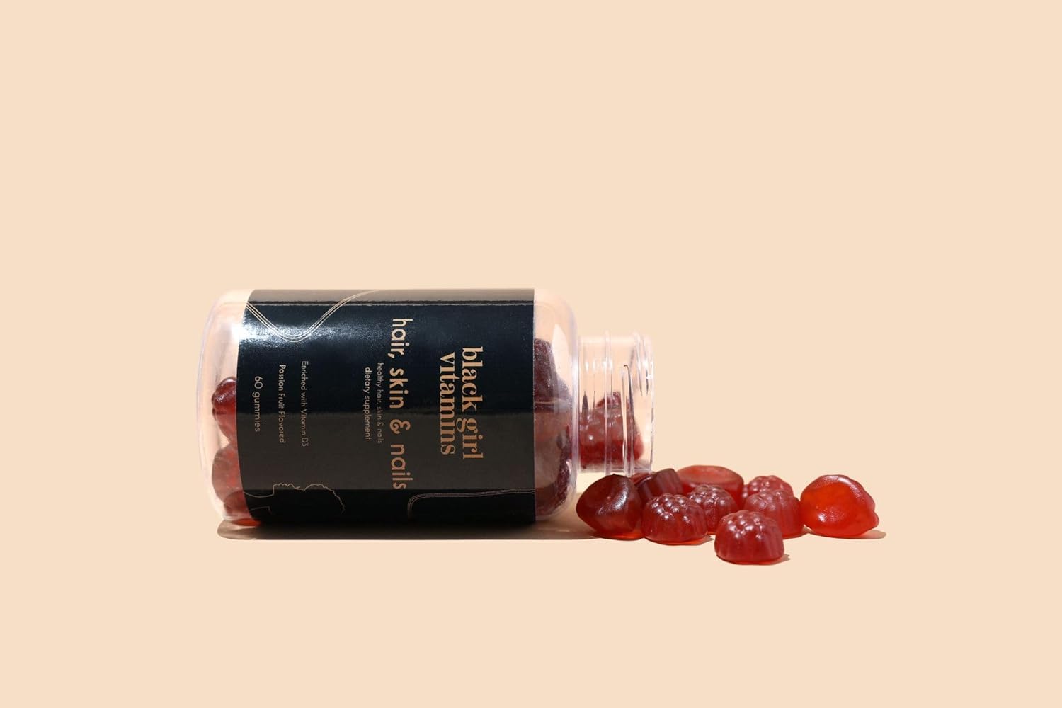 Black Girl Vitamins Biotin Gummies with a passion fruit next to them