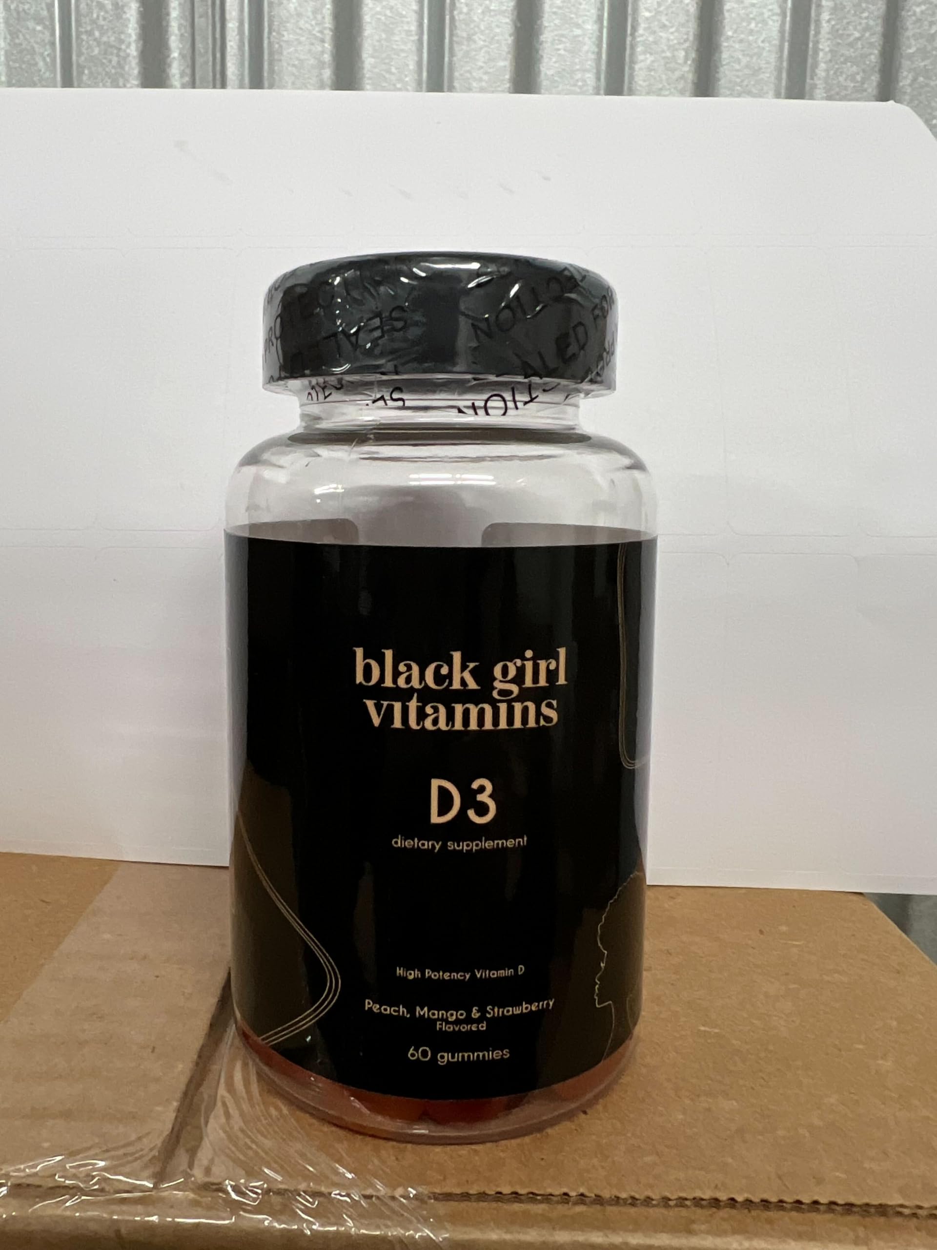 Black Girl Vitamins D3 Gummies arranged in a bowl with fruits
