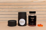 Black Girl Vitamins D3 Gummies on a wooden table with fresh fruits