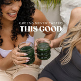 Bloom Nutrition Greens & Superfoods Powder in a glass of water