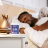 BrainMD Put Me to Sleep Naturally chewable tablet on a wooden surface