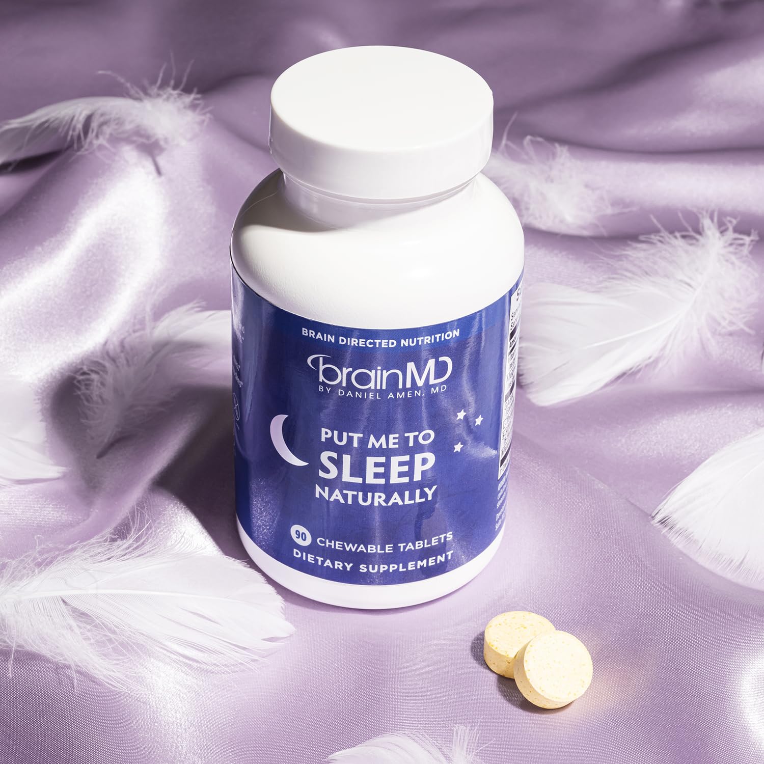BrainMD Put Me to Sleep Naturally on a bedside table