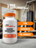BulkSupplements Creatine Monohydrate Capsules on a wooden table
