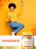 Carlyle Vitamin C + E Vegan Gummies with a measuring spoon