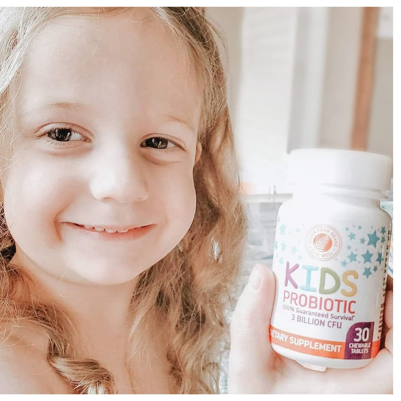 Child holding a Silver Fern Probiotic Chewable Tablet