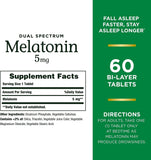Close-up of Nature's Bounty Dual Spectrum Melatonin tablet showing bi-layer design