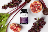 Close-up of Thomas' Resveratrol Plus capsules on a wooden surface