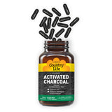 Country Life Activated Charcoal Vegan Capsules on a wooden table