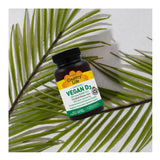 Country Life Vitamin D3 5000 IU Vegan Capsules with green leaves
