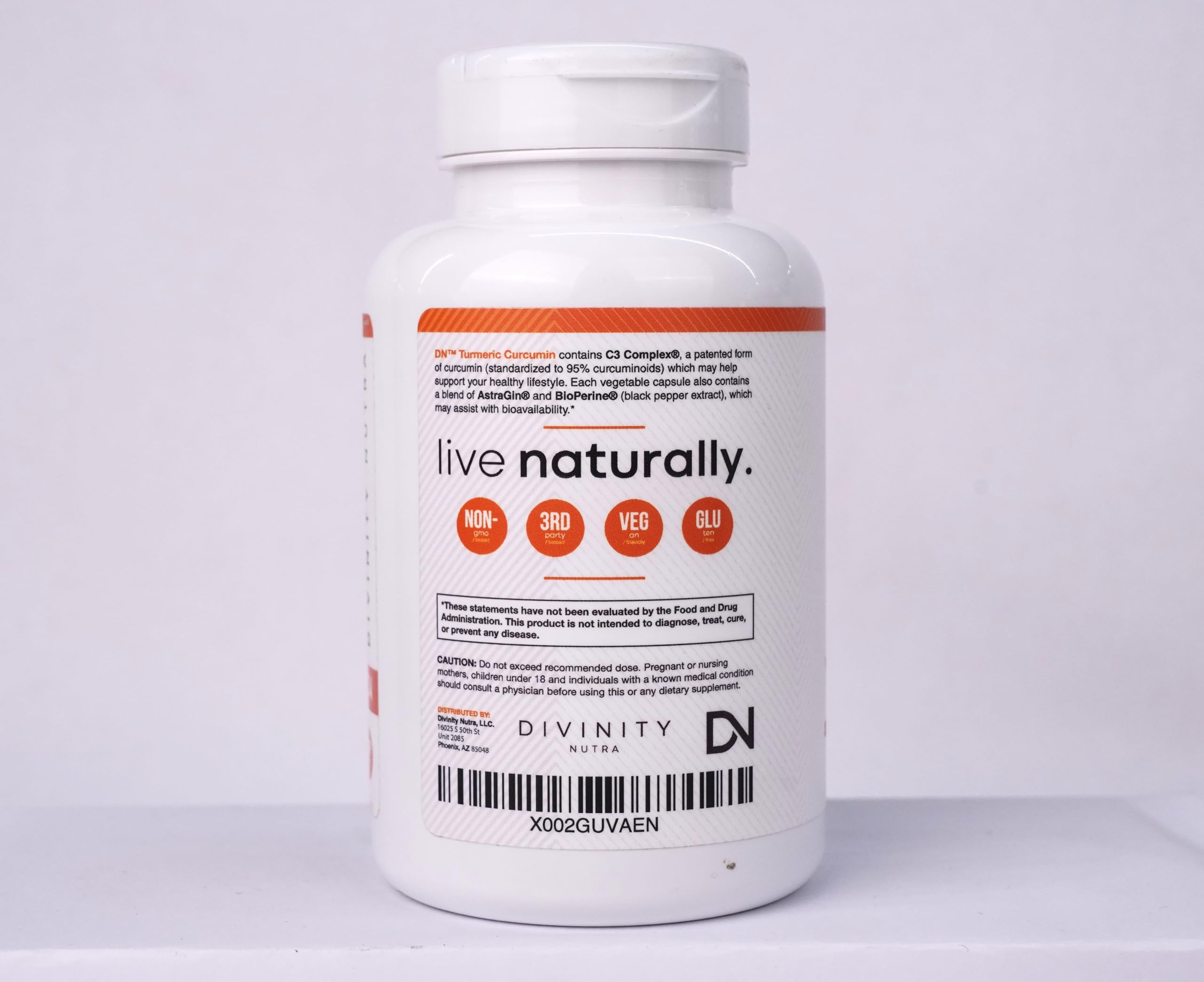 Divinity Nutra Turmeric Curcumin 1400mg supplement bottle with measuring spoon