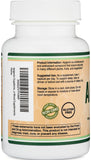 Double Wood Apigenin capsules in a hand