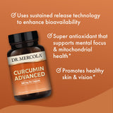 Dr. Mercola Curcumin Advanced capsules on a wooden table