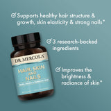 Dr. Mercola Hair, Skin & Nails Supplement capsules on a wooden surface