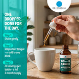 Dr. Robaina Vitamin D3 & K2 sublingual liquid on a wooden table