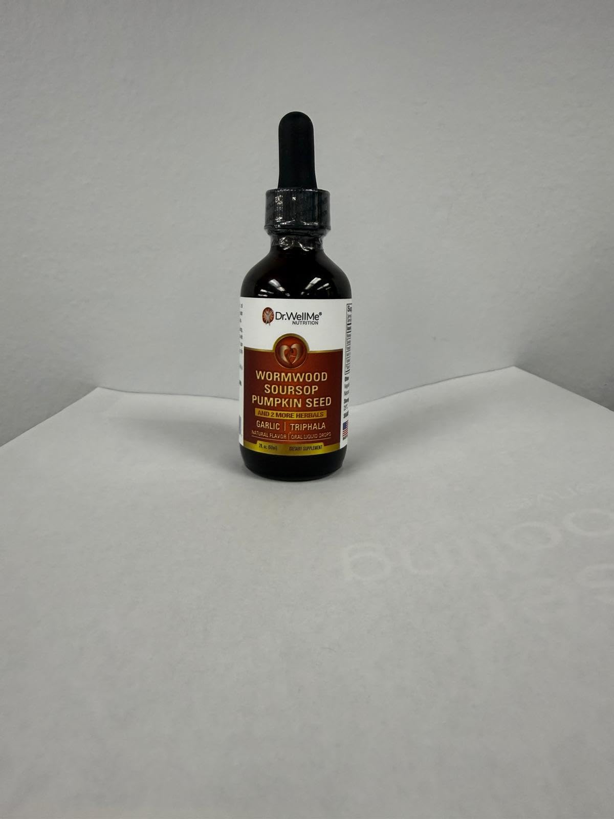 DR WELLME NUTRITION Soursop Turmeric Capsules on a wooden table
