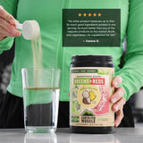 Earth Fed Muscle Greens + Reds Powder mixed in a glass