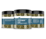 Earthborn Elements Peppermint Leaf Capsules on a wooden table