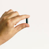 Earthborn Elements Spirulina Capsules on a wooden table