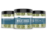 Earthborn Elements Wheat Grass Capsules on a wooden table