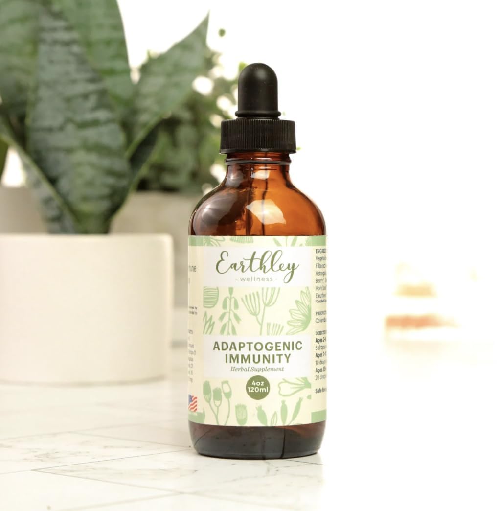 Earthley Wellness Adaptogenic daily wellness supplement opened with capsules
