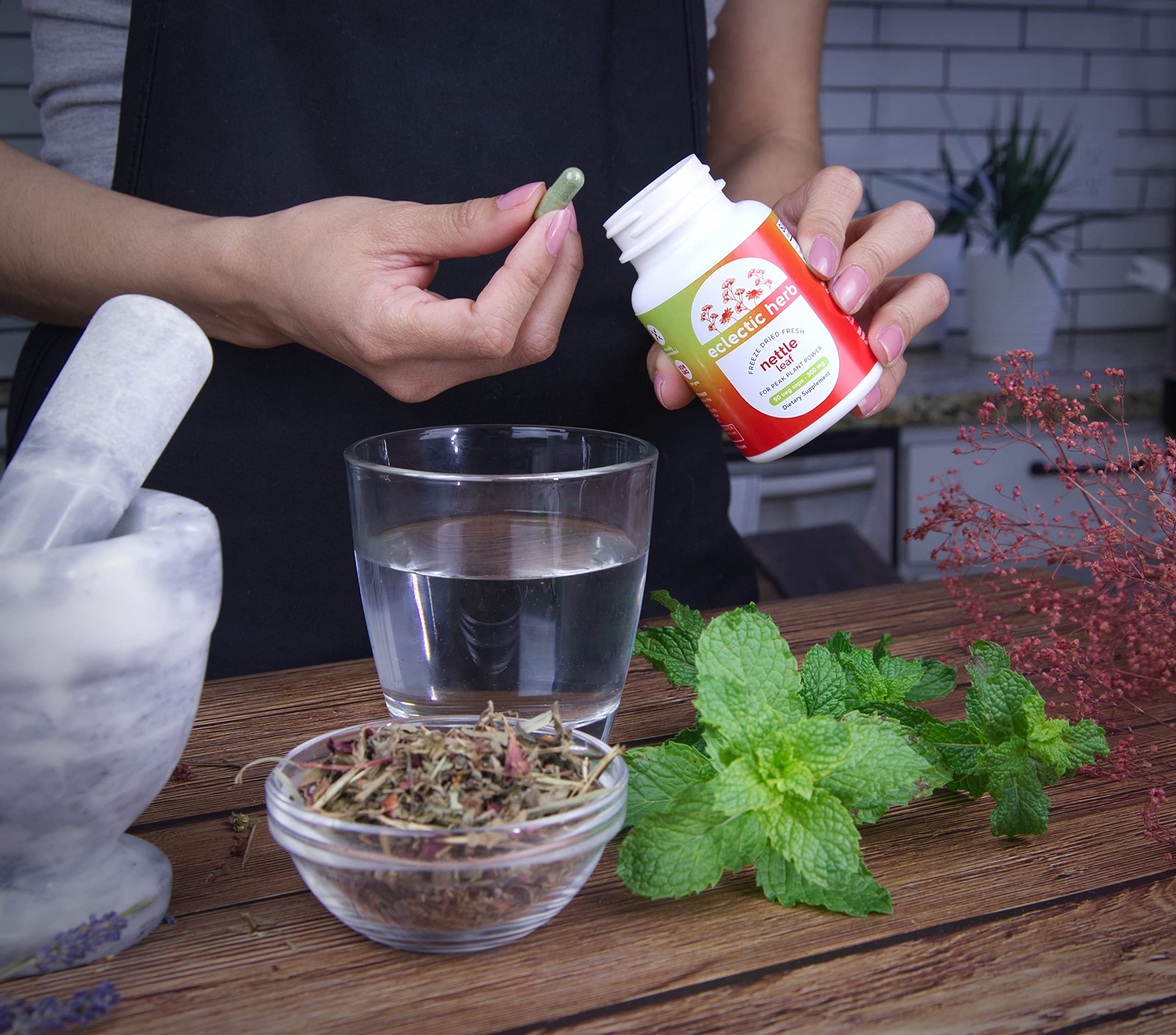 ECLECTIC INSTITUTE Nettle Leaf Capsules in hand