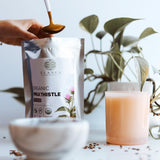 Elanen Naturals Organic Milk Thistle Seeds with a measuring spoon