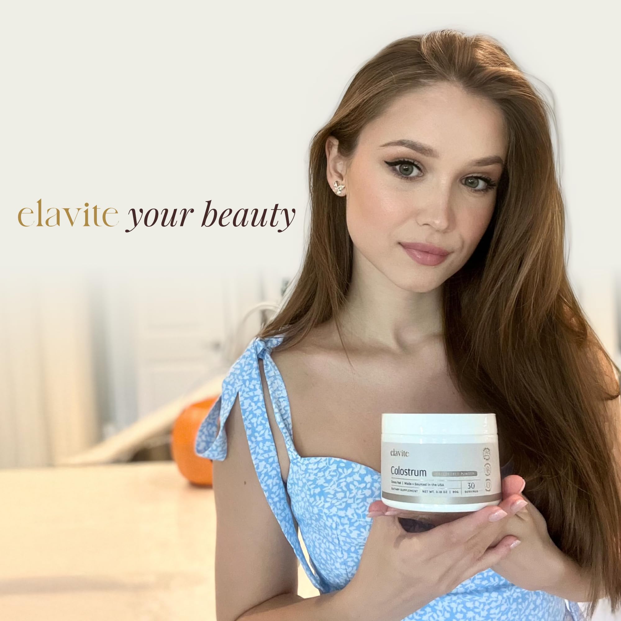 Elavite Bovine Colostrum Powder in a clear glass with water