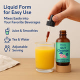 ELLORA Gut Cleanse Liquid Drops in a glass of juice