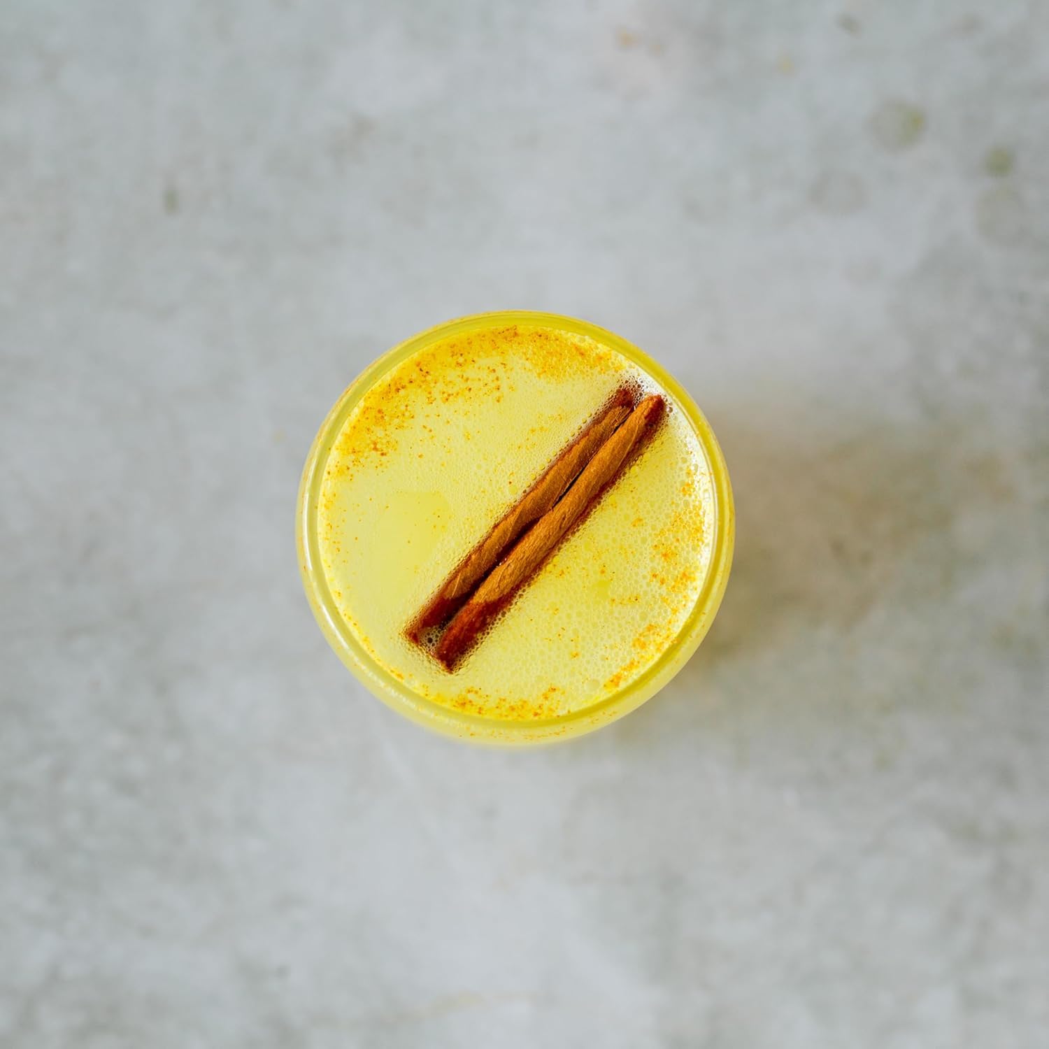 Erbology Organic Turmeric Root Powder in a bowl with fresh turmeric root