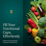 Etta Vita Arjuna Supplement on a kitchen counter with fresh fruits and vegetables