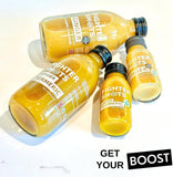 Fighter Shots Ginger and Turmeric Wellness Shots on a wooden table