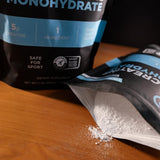 Fluid Creatine Monohydrate 100 servings unflavoured powder on a kitchen counter