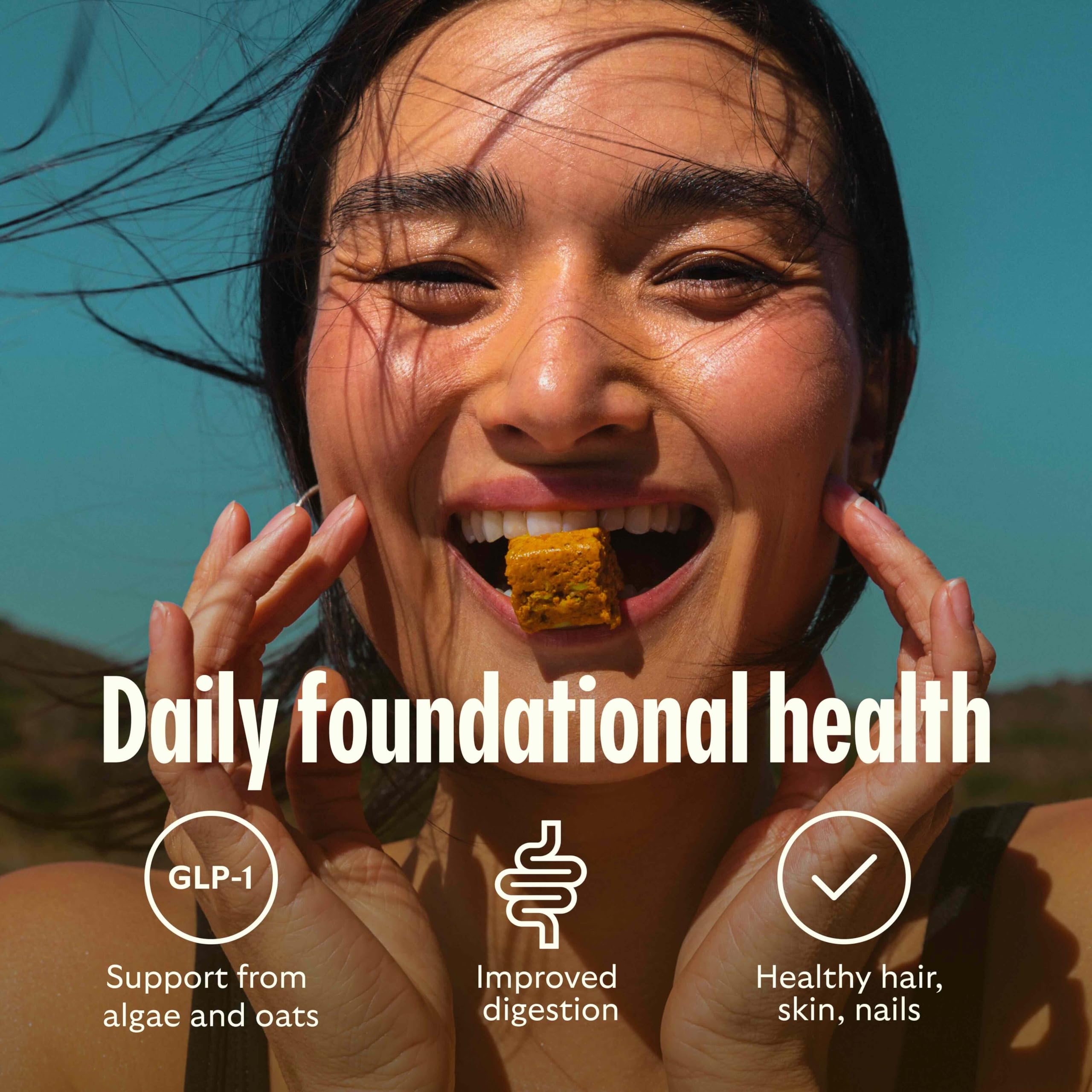 GEM Multivitamin Energy Bites alongside a glass of water