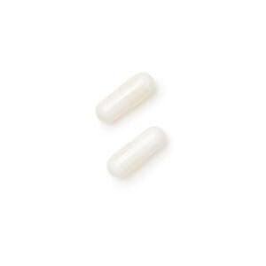GNC Magnesium Supplement 120 Capsules on a wooden table