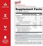 Goli daily Supplement Capsules on a wooden table