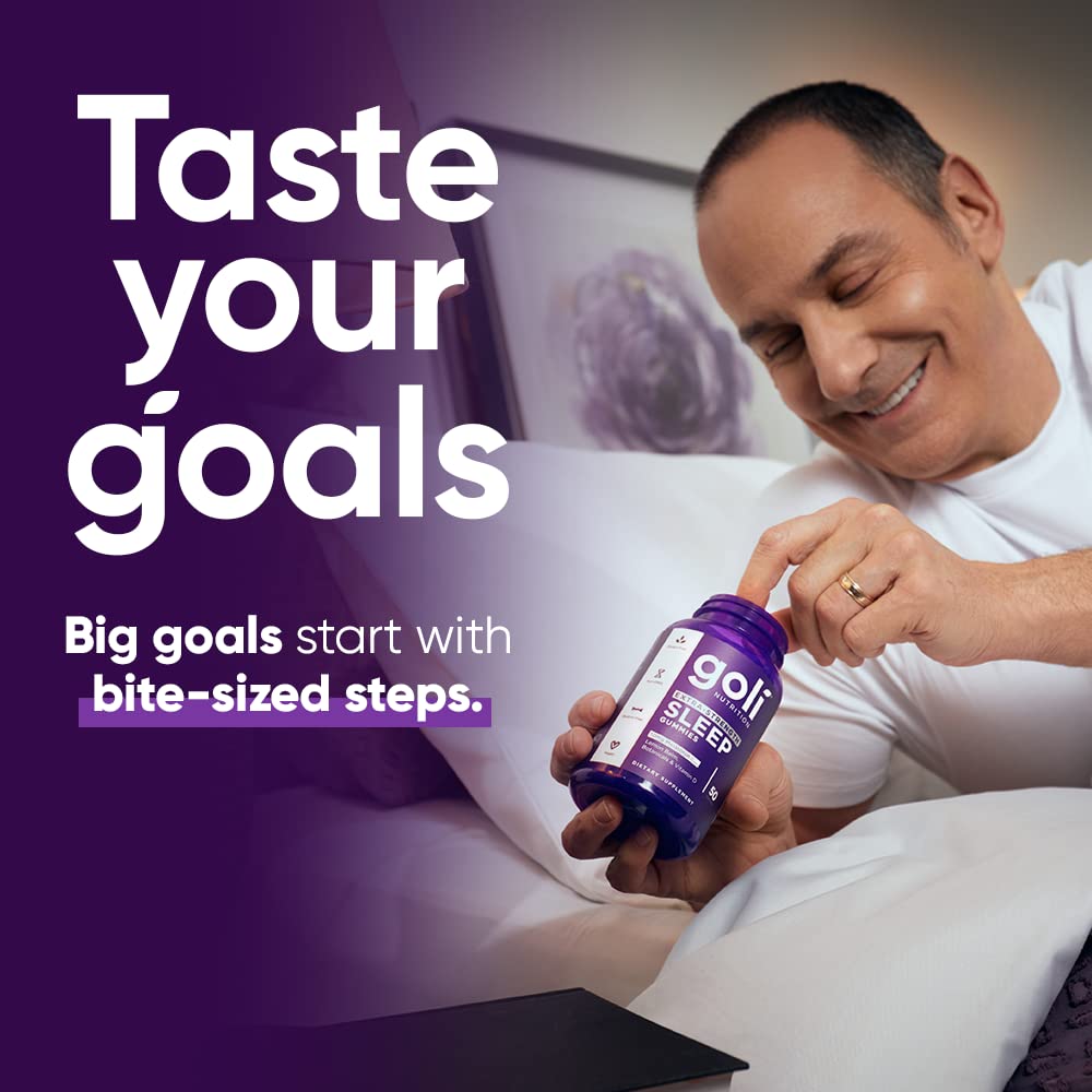 Goli Extra-Strength Sleep Gummies on a table with a glass of water