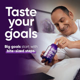 Goli Extra-Strength Sleep Gummies on a table with a glass of water