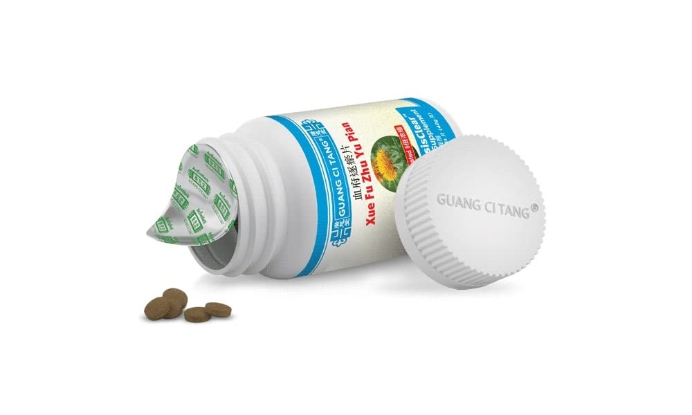Guang Ci Tang Blood StasisClear Xue Fu Zhu Yu Pian tablets on a wooden surface