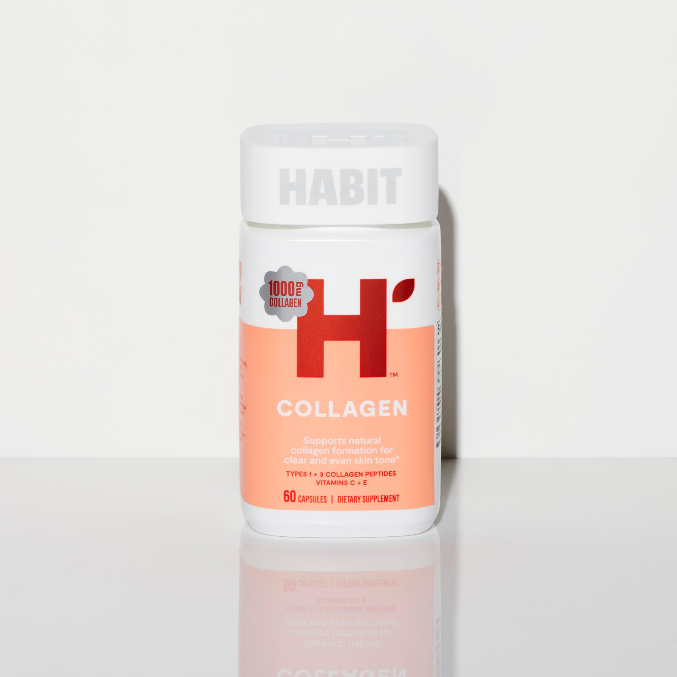 H' Habit Collagen Supplement capsules on a wooden surface