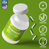HARMONIFY Moringa Capsules on a wooden table with greenery